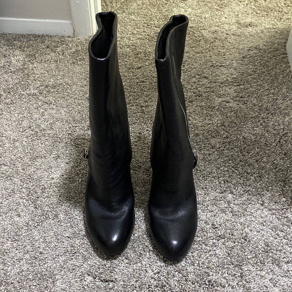 Black boots. Mid-calf height. 3 in heal. Zipper design is functional and pretty.